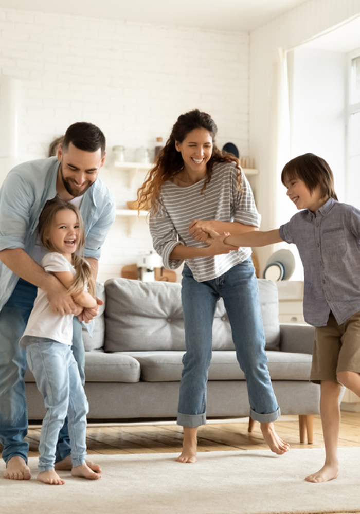 Family playing and laughing in living room